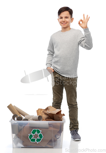 Image of smiling boy sorting paper waste showing ok sign