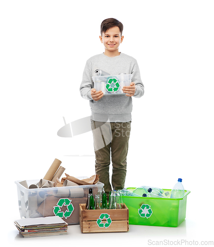 Image of smiling boy sorting paper, metal and plastic waste