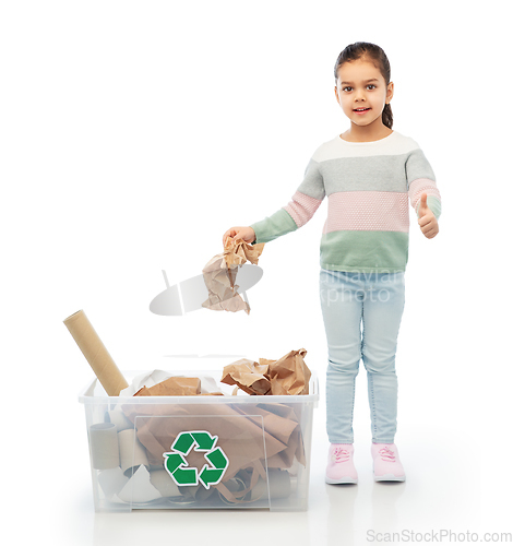 Image of girl sorting paper waste and showing thumbs up