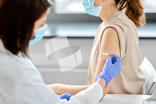 Image of close up of doctor attaching patch to patient