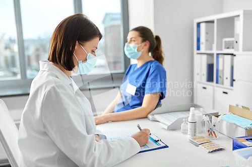 Image of doctor with clipboard and nurse at hospital