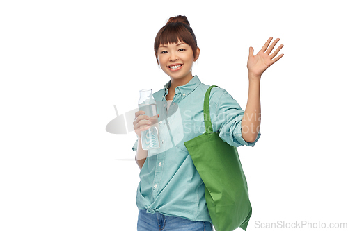 Image of woman with bag for food shopping and glass bottle