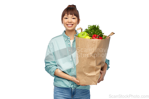 Image of happy asian woman with food in paper shopping bag