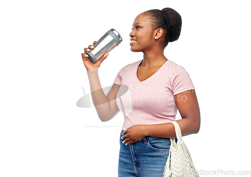 Image of woman with tumbler and food in string bag