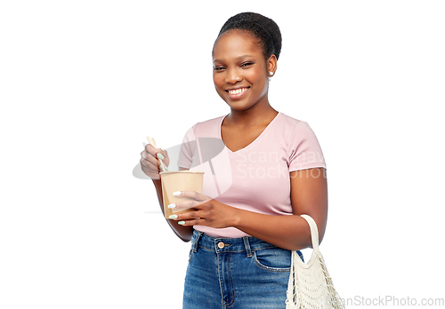 Image of happy woman with reusable bag for food and wok