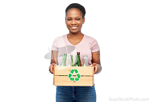 Image of happy african american woman sorting glass waste