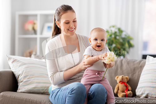 Image of happy smiling mother with little baby at home