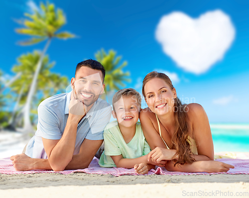 Image of happy family lying over tropical beach background