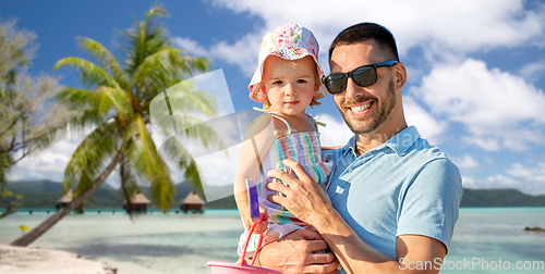 Image of happy father with little daughter on beach