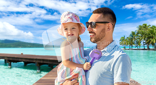 Image of happy father with little daughter on beach