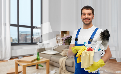 Image of male cleaner with cleaning supplies at home