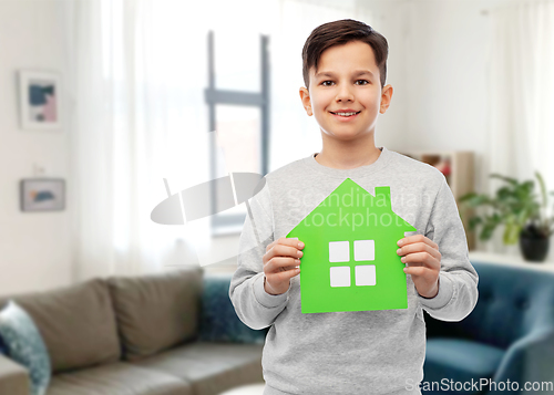 Image of smiling boy holding green house icon