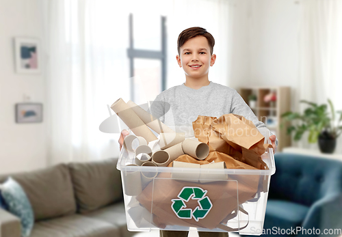 Image of smiling boy sorting paper waste