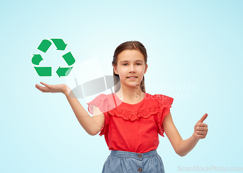 Image of girl showing thumbs up and holding recycling sign