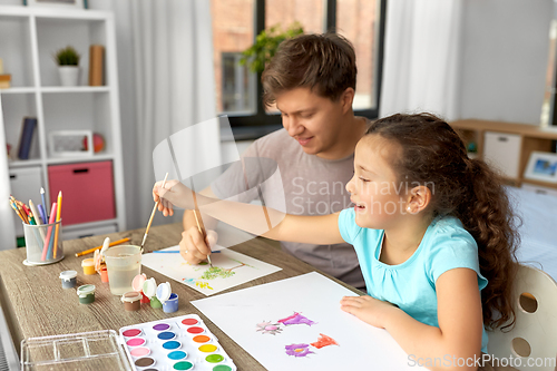 Image of happy father with little daughter drawing at home