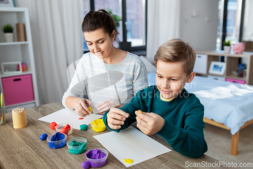 Image of mother and son playing with modeling clay at home