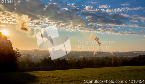 Image of industrial cityscape with with smoking factory
