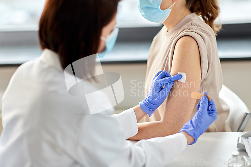 Image of close up of doctor attaching patch to patient