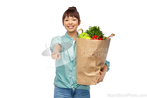 Image of happy asian woman with food in paper shopping bag