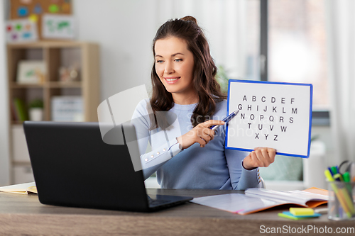 Image of teacher with alphabet having online class at home