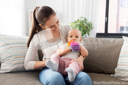 Image of happy smiling mother with little baby at home