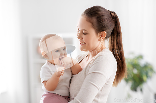 Image of happy mother with little baby daughter at home