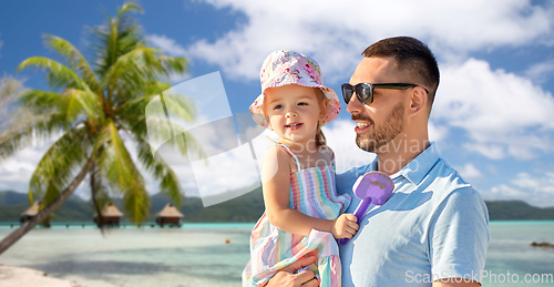 Image of happy father with little daughter on beach