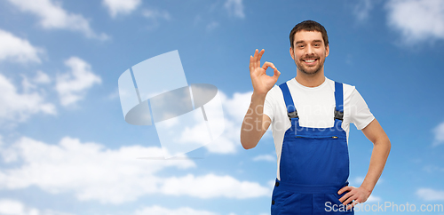 Image of happy smiling male worker or builder showing ok