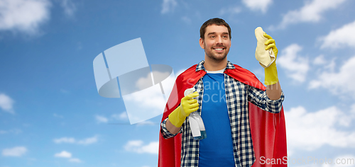 Image of smiling man in superhero cape with rag and cleaner