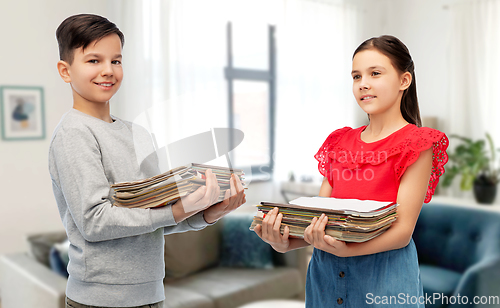 Image of boy and girl with magazines sorting paper waste