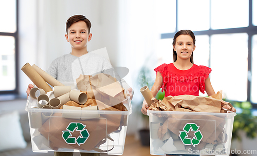 Image of smiling girl and boy sorting paper waste