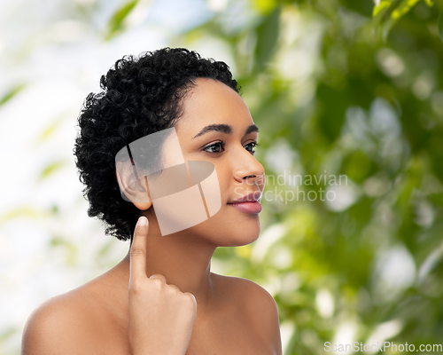 Image of african american woman showing her ear