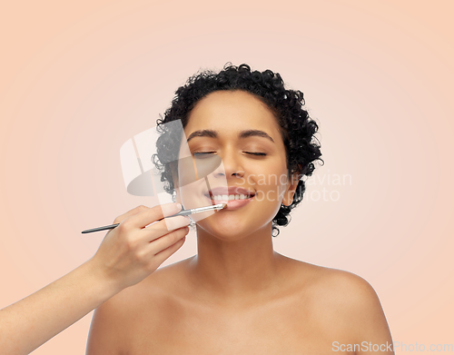 Image of happy woman and hand of make up artist with brush