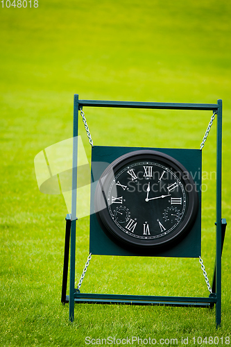 Image of Outdoor Clock on golf course with green spring valley on the bac