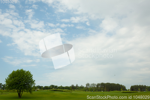 Image of lush fairway in the foreground contrast in the distance at a gol