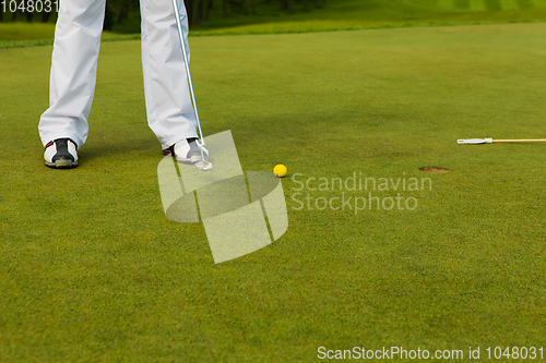 Image of Playing golf. Golf club and ball. Preparing to shot