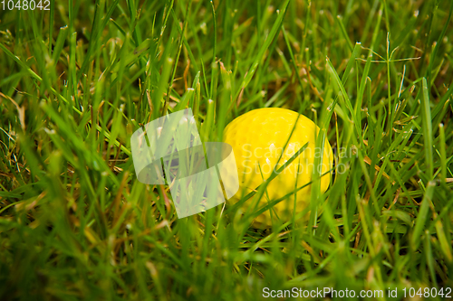 Image of Golf ball on a tee against the golf course with copy space