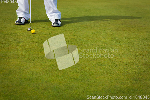 Image of Playing golf. Golf club and ball. Preparing to shot