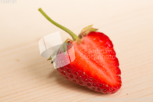 Image of Fresh, juicy strawberries on a wood table. 