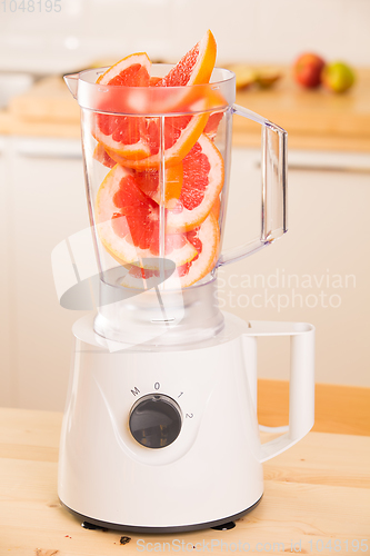 Image of Grapefruit white Blender on a wooden table.