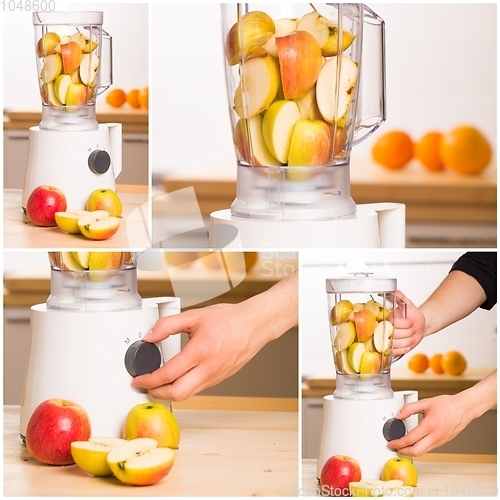 Image of White blender with apples on a wooden table.