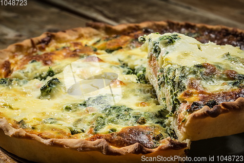 Image of Traditional French cake. quiche with chard in white. Dark wood background. free space text.