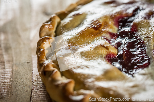 Image of Berry pie with blueberries close-up on a plate on the table. horizontal