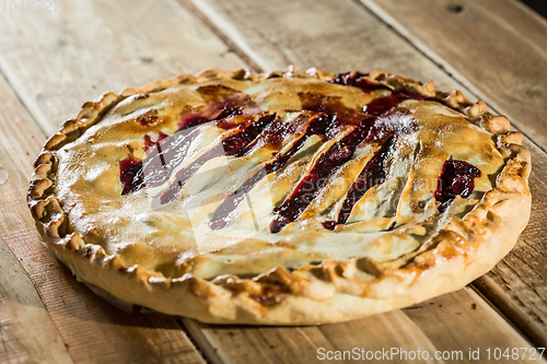 Image of Berry pie with blueberries close-up on a plate on the table. horizontal