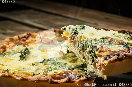 Image of Traditional French cake. quiche with chard in white. Dark wood background. free space text.