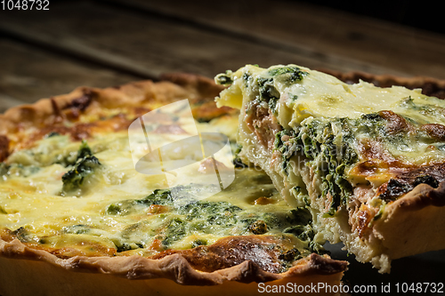 Image of Traditional French cake. quiche with chard in white. Dark wood background. free space text.