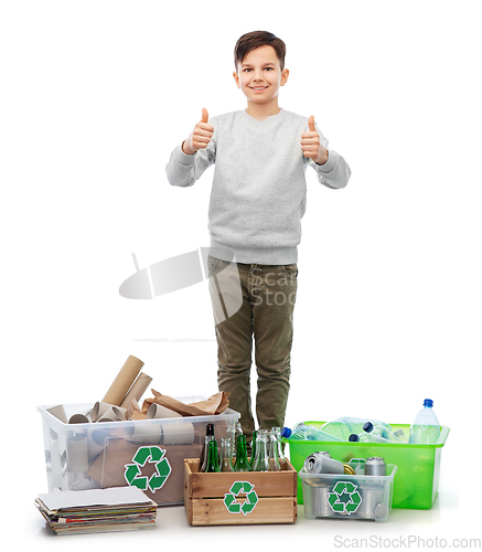 Image of smiling boy sorting paper, metal and plastic waste