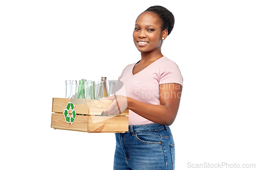 Image of happy african american woman sorting glass waste