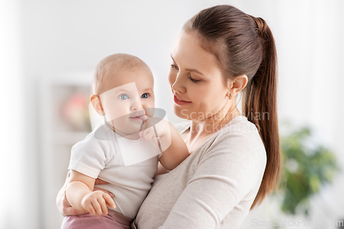 Image of happy mother with little baby daughter at home