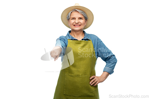 Image of portrait of smiling senior woman in garden apron